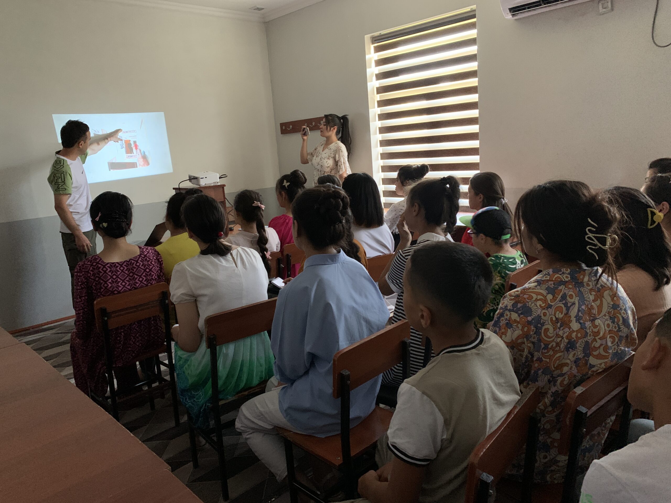 Ahrorjon giving an educational presentation about studying in Korea to prospective students in Tajikistan